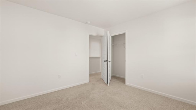605 Lobelia Way, Locust Grove, GA 30248 - unfurnished bedroom with light colored carpet, baseboards, and a closet