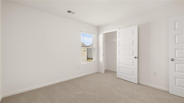 605 Lobelia Way, Locust Grove, GA 30248 - unfurnished bedroom featuring light carpet, baseboards, and a closet