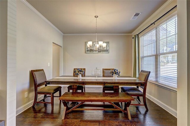 dining space with visible vents, baseboards, a chandelier, crown molding, and wood finished floors