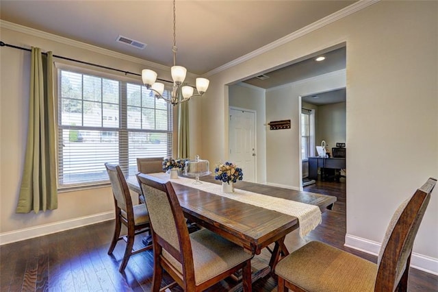 dining space with a notable chandelier, dark wood-type flooring, visible vents, and baseboards