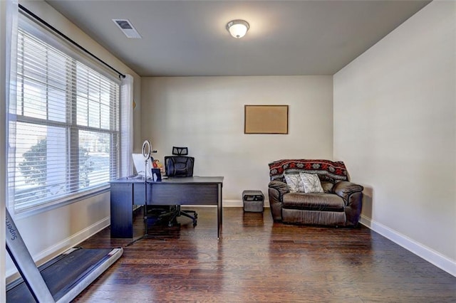 home office featuring wood finished floors, baseboards, and visible vents