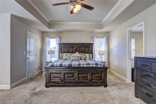 bedroom featuring baseboards, light carpet, a raised ceiling, crown molding, and ceiling fan