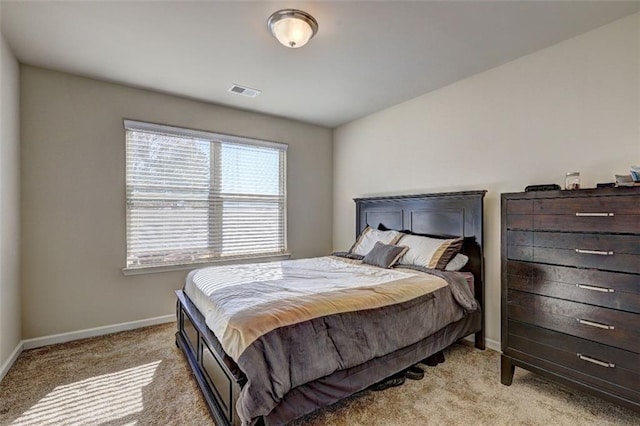 bedroom featuring light carpet, visible vents, and baseboards