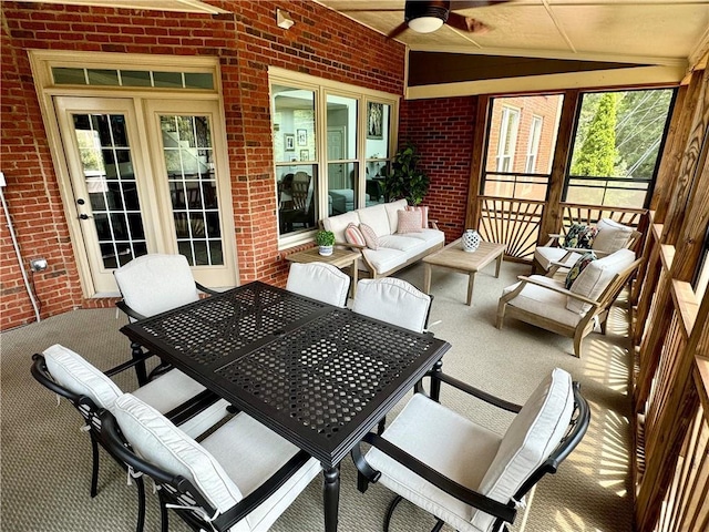 sunroom / solarium with vaulted ceiling and a ceiling fan