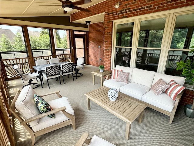 sunroom with vaulted ceiling and a ceiling fan