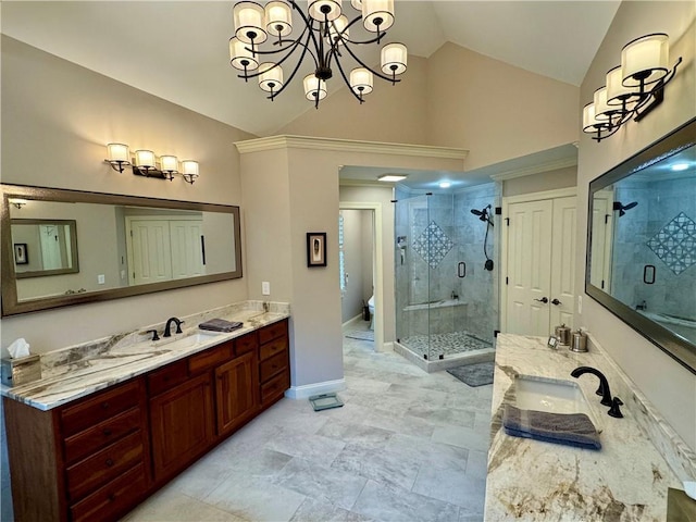 bathroom with toilet, two vanities, vaulted ceiling, a shower stall, and a sink