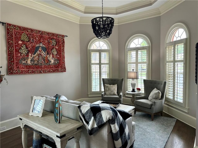 living area with dark wood-style floors, baseboards, and ornamental molding