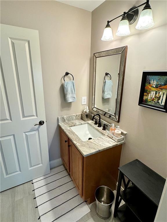 bathroom with baseboards and vanity