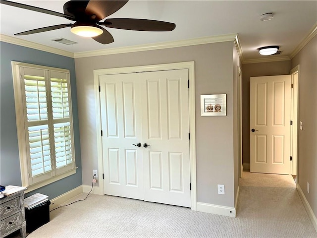 unfurnished bedroom with light colored carpet, visible vents, crown molding, and multiple windows