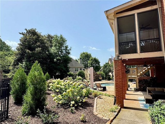 view of yard featuring a patio area, fence, a ceiling fan, and an outdoor pool