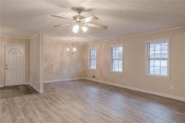 unfurnished room featuring ornamental molding, wood-type flooring, ceiling fan with notable chandelier, and a textured ceiling