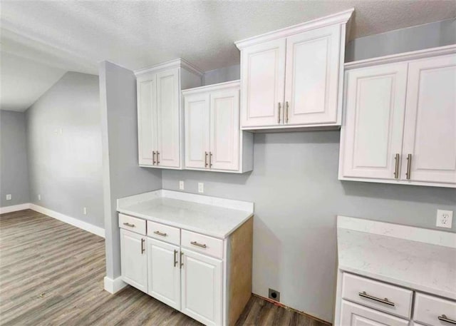 kitchen with white cabinetry, dark hardwood / wood-style flooring, and a textured ceiling