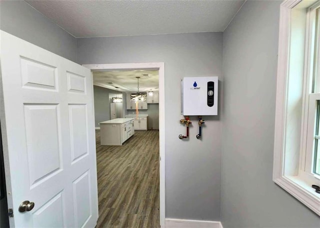 hall featuring dark hardwood / wood-style floors and a textured ceiling