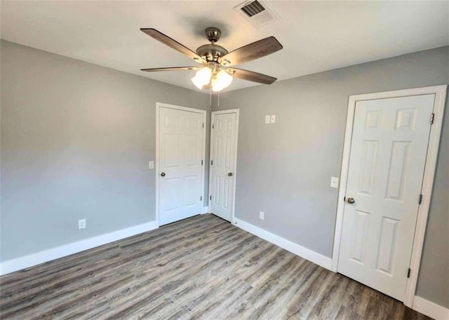 spare room featuring hardwood / wood-style floors and ceiling fan