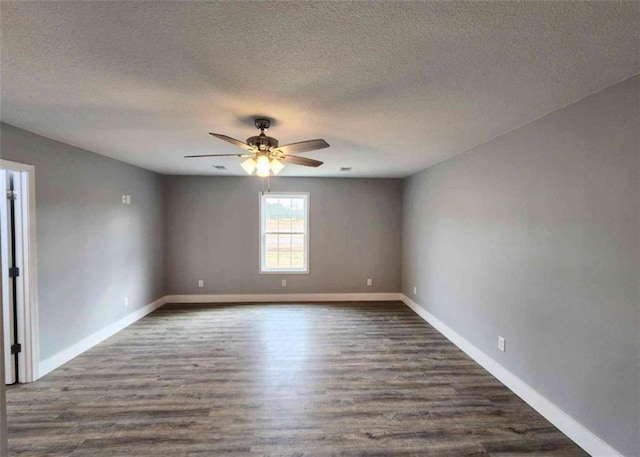 empty room featuring dark wood-type flooring, a textured ceiling, and ceiling fan