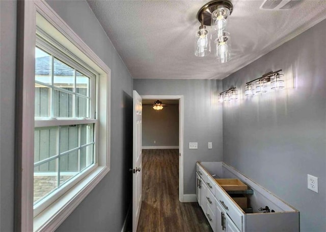 bathroom with wood-type flooring and a textured ceiling