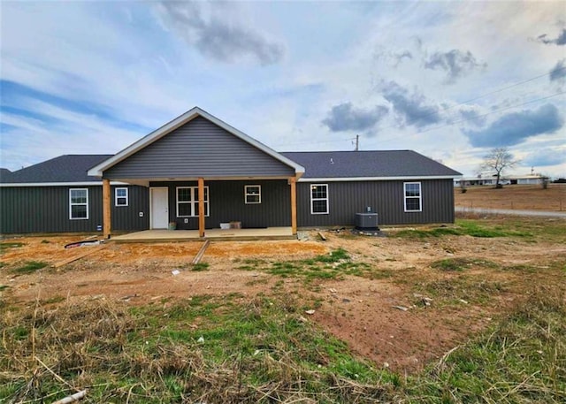 rear view of house featuring cooling unit and a patio area