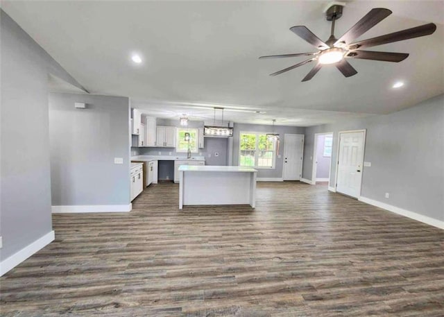 kitchen with white cabinetry, ceiling fan, dark hardwood / wood-style flooring, and pendant lighting