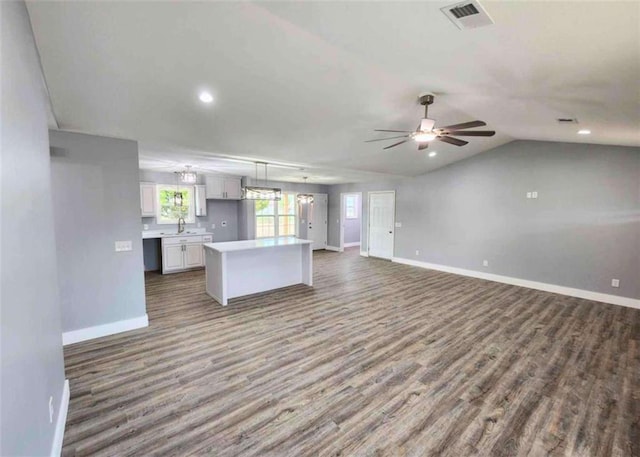 kitchen featuring sink, ceiling fan, white cabinetry, dark hardwood / wood-style flooring, and decorative light fixtures