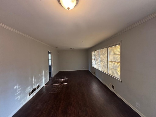 empty room featuring dark hardwood / wood-style flooring and crown molding