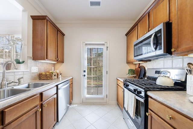 kitchen with visible vents, appliances with stainless steel finishes, light countertops, and a sink