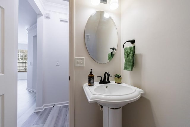 bathroom with baseboards and wood finished floors