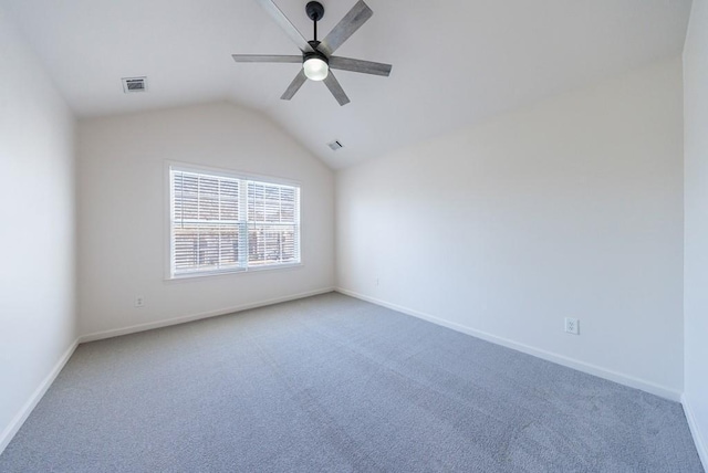 spare room featuring visible vents, light carpet, lofted ceiling, a ceiling fan, and baseboards