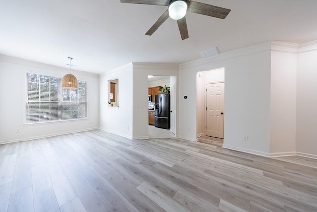 unfurnished living room with light wood finished floors, visible vents, crown molding, and baseboards