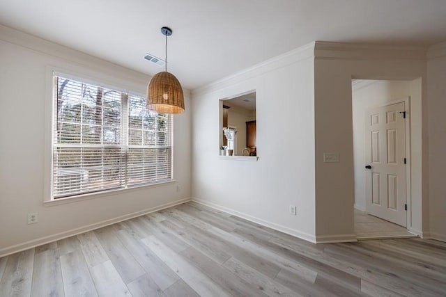 unfurnished dining area featuring baseboards, visible vents, light wood finished floors, and ornamental molding