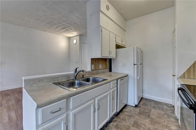 kitchen featuring white appliances, a sink, baseboards, white cabinets, and light countertops