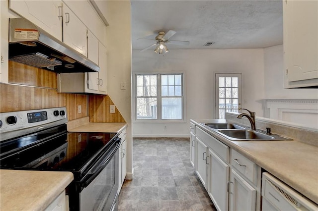 kitchen with white cabinets, under cabinet range hood, electric range, and light countertops