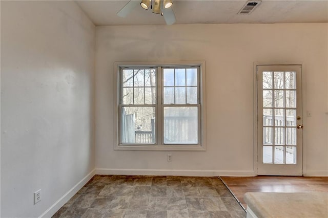 interior space featuring visible vents, ceiling fan, and baseboards