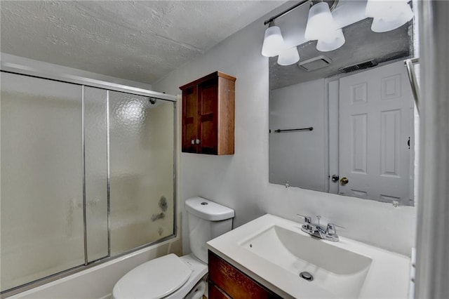 bathroom with bath / shower combo with glass door, visible vents, toilet, a textured ceiling, and vanity