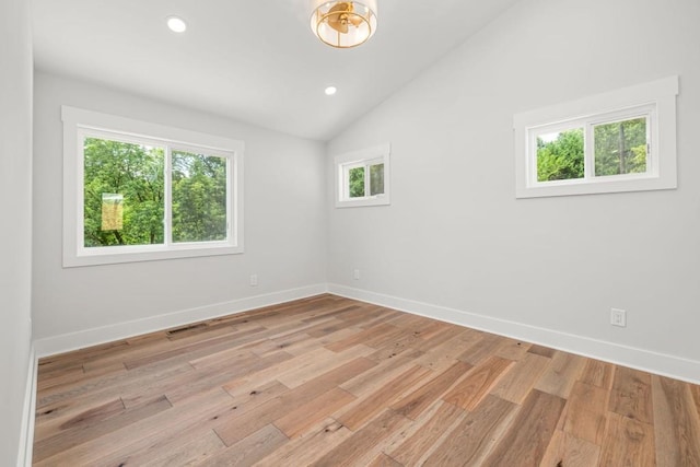 unfurnished room featuring vaulted ceiling, recessed lighting, baseboards, and light wood-style floors