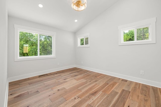 6564 Bermuda Ln, Flowery Branch, GA 30542 - spare room featuring light wood-type flooring, vaulted ceiling, baseboards, and recessed lighting