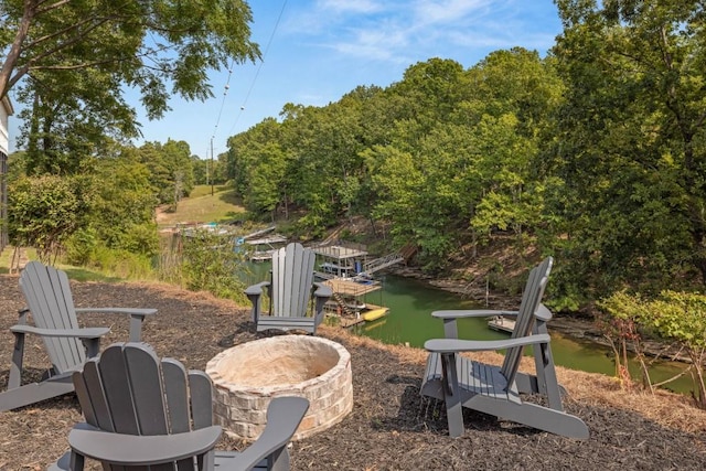 view of yard featuring a water view and a boat dock