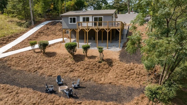 rear view of house featuring a patio area, a wooden deck, and stairs