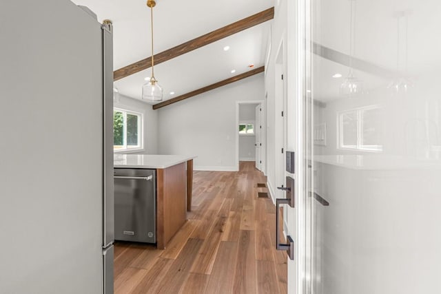 6564 Bermuda Ln, Flowery Branch, GA 30542 - kitchen with stainless steel appliances, light wood finished floors, light countertops, hanging light fixtures, and baseboards