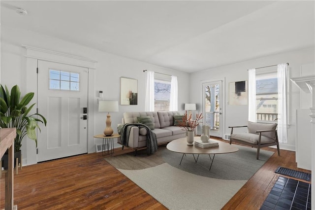 living area featuring visible vents and hardwood / wood-style floors