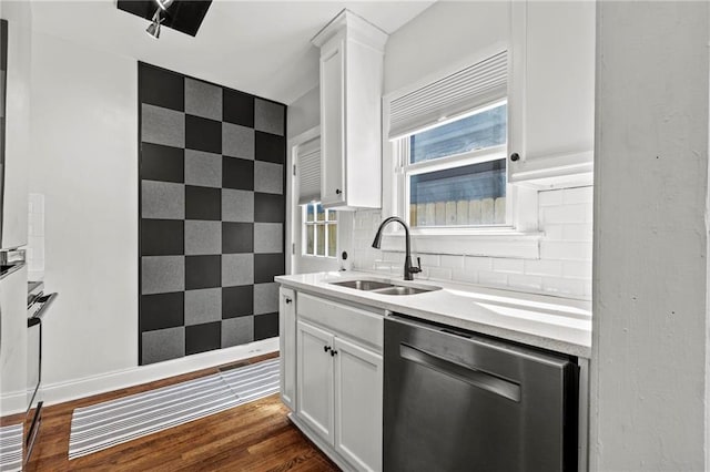 kitchen with a sink, white cabinets, decorative backsplash, dishwasher, and dark wood finished floors