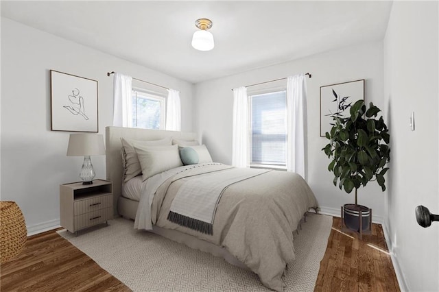 bedroom featuring wood finished floors and baseboards