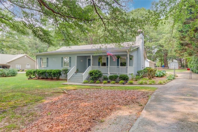 1980 Mcconnell Rd, Grayson, GA 30017 - view of front of home with a porch, a chimney, and a front lawn