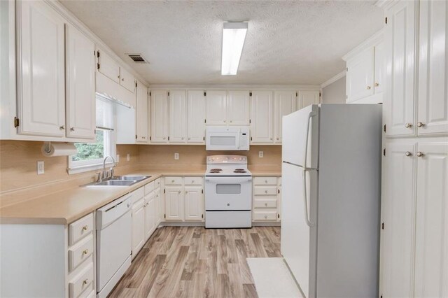 1980 Mcconnell Rd, Grayson, GA 30017 - kitchen with white appliances, a sink, light wood-style flooring, white cabinetry, and light countertops