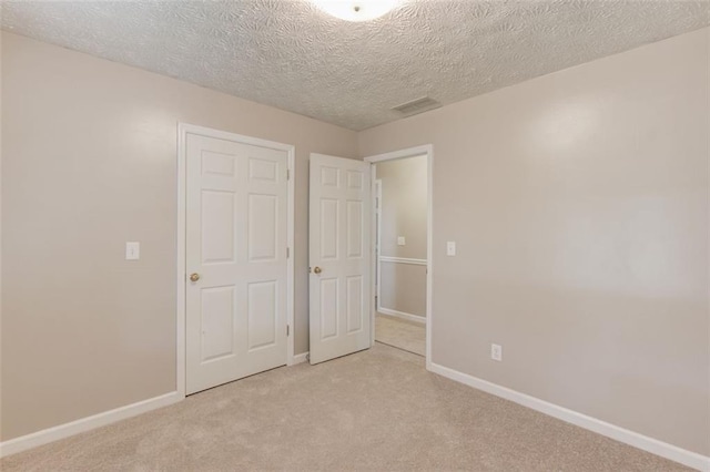 1980 Mcconnell Rd, Grayson, GA 30017 - unfurnished bedroom featuring light carpet, baseboards, and a textured ceiling