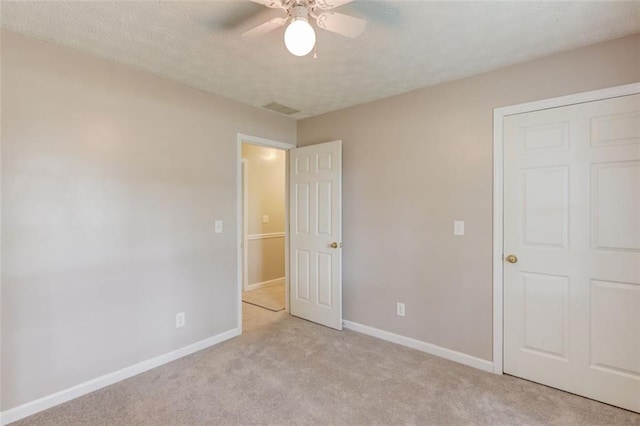 1980 Mcconnell Rd, Grayson, GA 30017 - unfurnished bedroom featuring light carpet, baseboards, a textured ceiling, and ceiling fan
