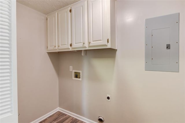 1980 Mcconnell Rd, Grayson, GA 30017 - laundry room featuring electric panel, hookup for an electric dryer, hookup for a washing machine, cabinet space, and wood finished floors