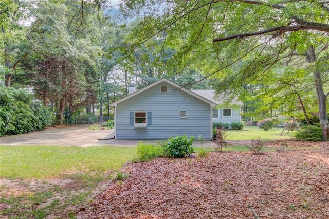 1980 Mcconnell Rd, Grayson, GA 30017 - view of side of home featuring a chimney and a lawn