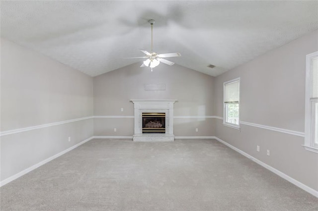 1980 Mcconnell Rd, Grayson, GA 30017 - unfurnished living room featuring a glass covered fireplace, light carpet, a ceiling fan, lofted ceiling, and baseboards