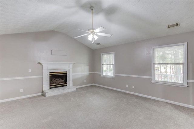 1980 Mcconnell Rd, Grayson, GA 30017 - unfurnished living room with a ceiling fan, vaulted ceiling, carpet floors, a fireplace, and a textured ceiling