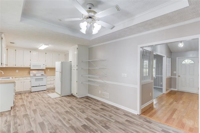 1980 Mcconnell Rd, Grayson, GA 30017 - kitchen with white appliances, a raised ceiling, a sink, light wood-style flooring, and light countertops